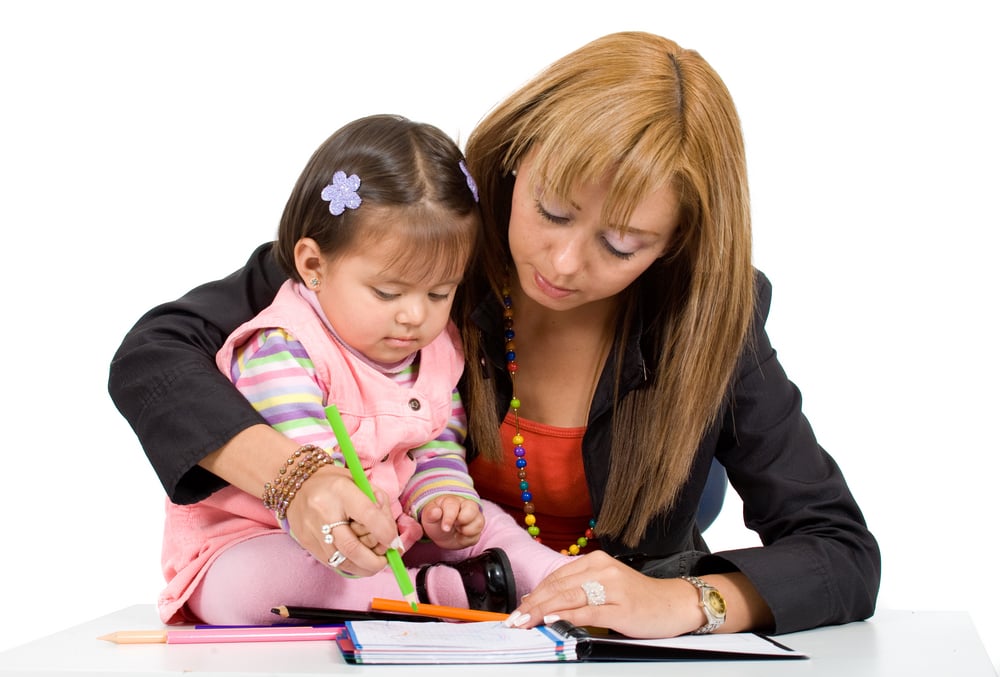 mother teaching her little girl - isolated over a white background