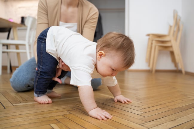 parent-helping-baby-crawl-high-angle-B-12 comp